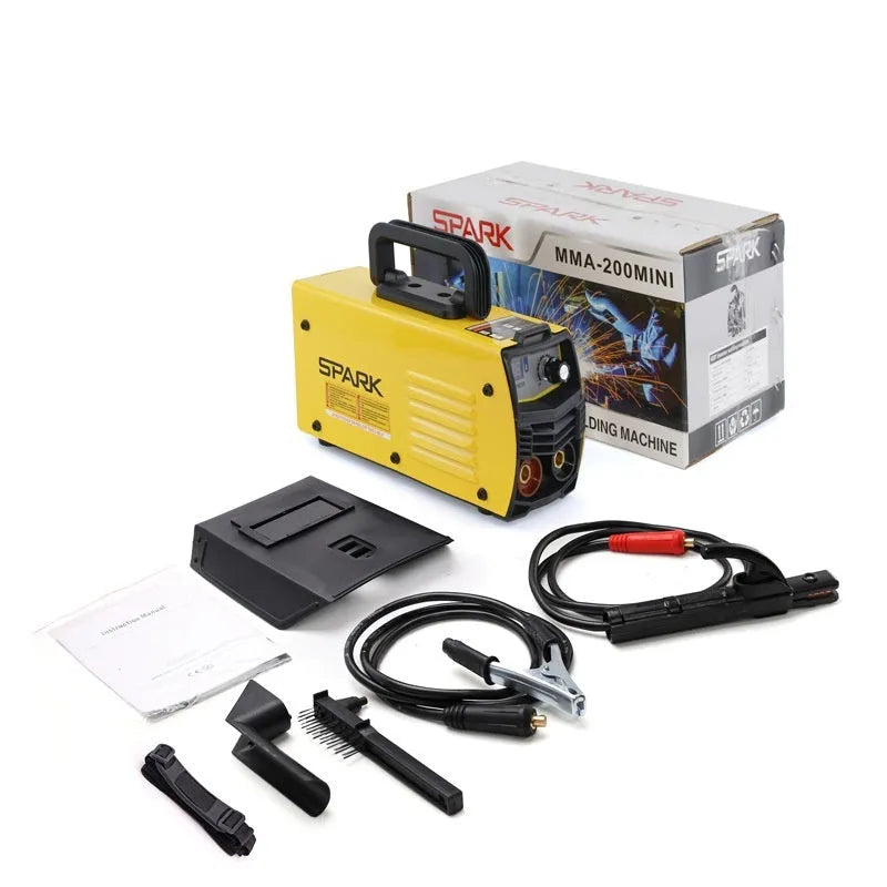Small portable DC welding machine with red housing, welding tongs, and face shield on a workshop bench