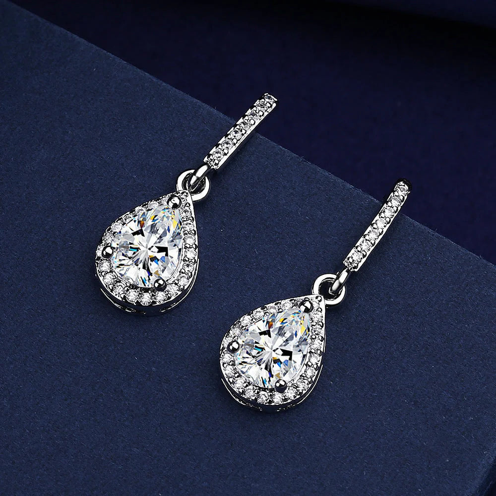 Elegant drop-shaped earrings featuring shimmering zircon stones in a variety of colors, including white, yellow, blue, and red diamond.