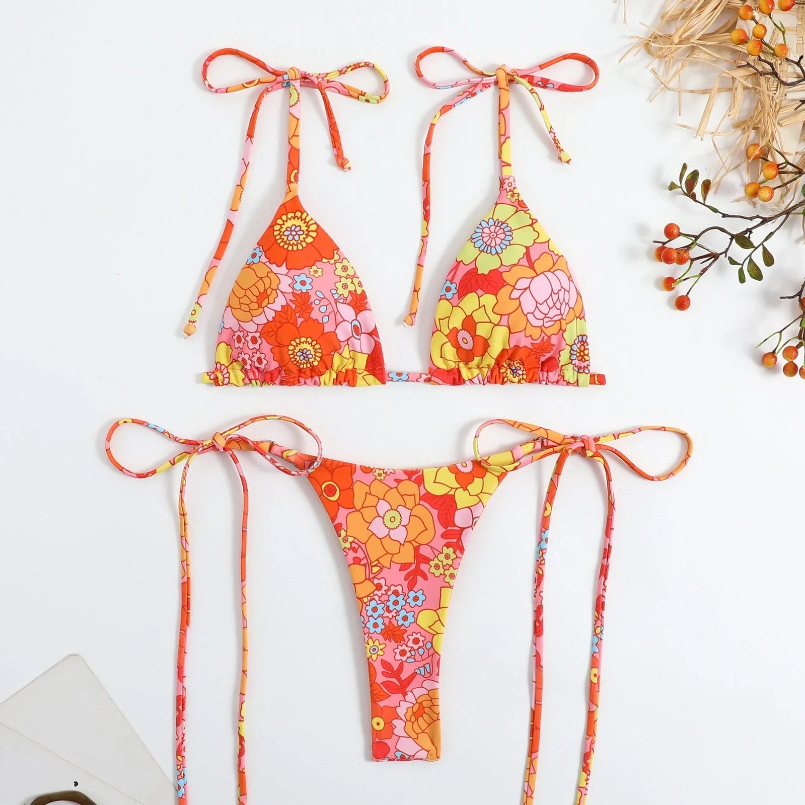 Women's split swimwear bikini set with backless design and floral pattern in available colours