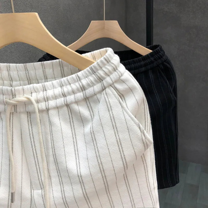 Men's black and white striped casual shorts with fleece lining, straight-leg cut, and ankle banding, shown in size M with waist 51cm