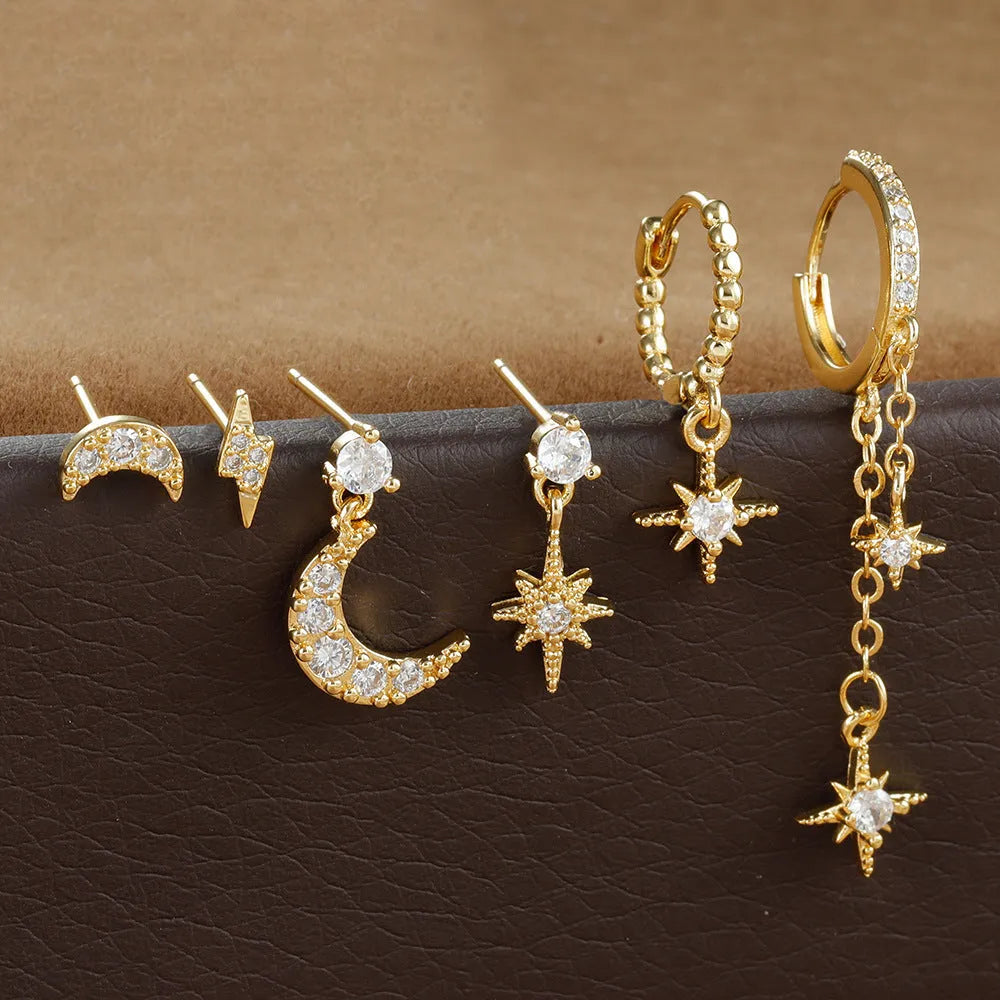 XINGX gold chain tassel earrings set showing six zircon stud earrings with dangling chain elements