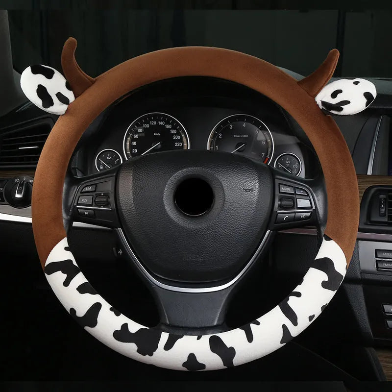 Short plush automotive steering wheel cover in black colour showing soft texture.