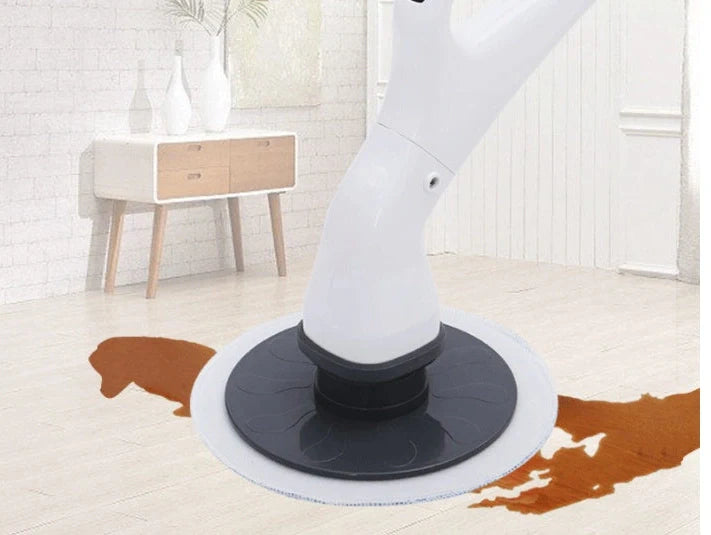 Wireless electric cleaning brush with mop heads, brush attachments, and charger on countertop