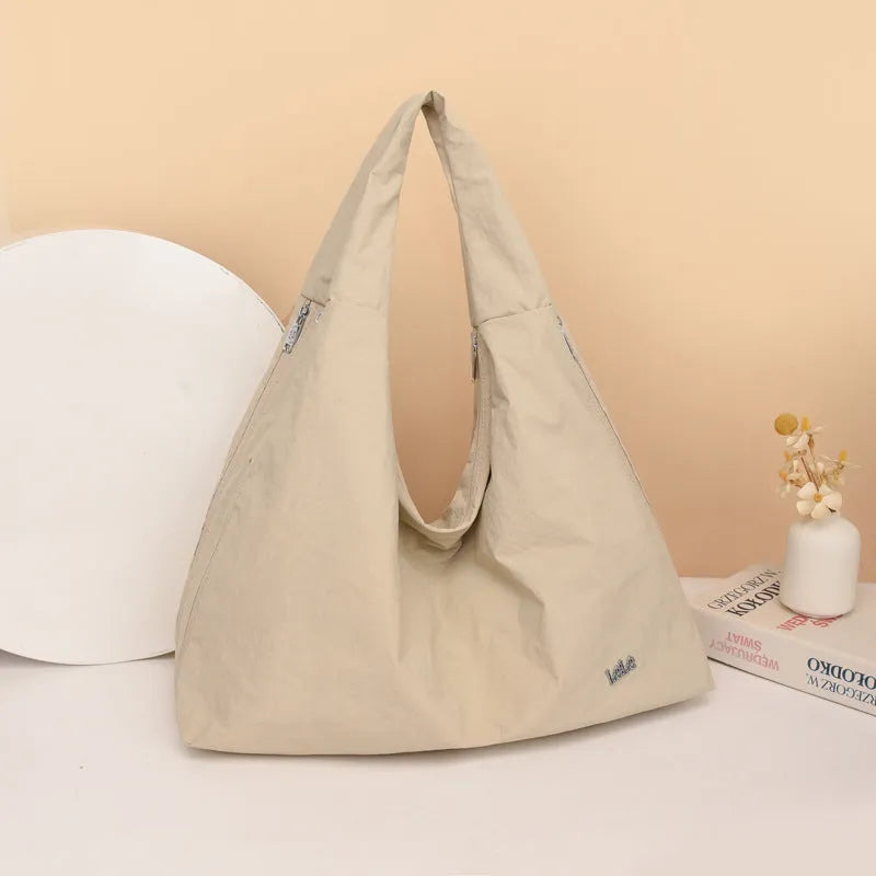 Heart-shaped soft nylon underarm shoulder bag for women in black, blue, khaki, or yellow.