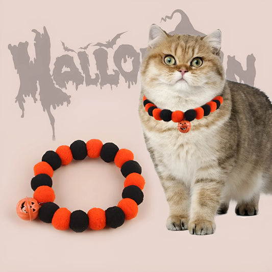 Orange pumpkin-shaped cat collar with a naughty cat face print, laid flat.