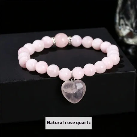 Handmade women's bracelet with natural gemstone beads and a silver love pendant charm.