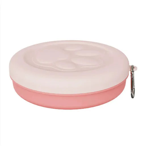 Collapsible silicone dog bowl with integrated snack compartment in light pink colour