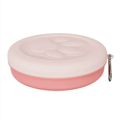 Collapsible silicone dog bowl with integrated snack compartment in light pink colour