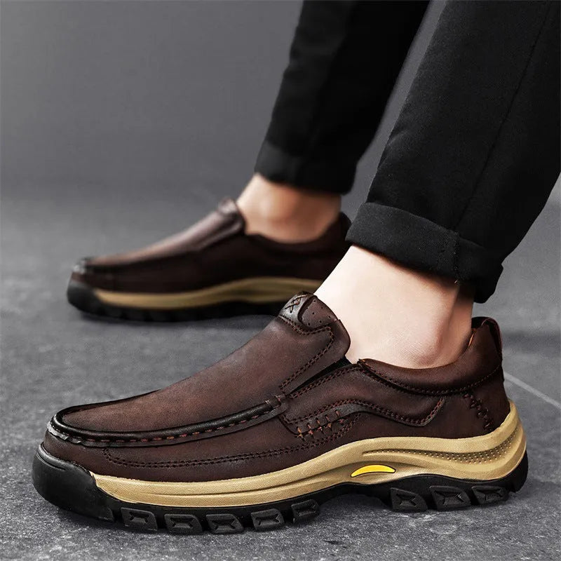 Men's black leather mountaineering shoes with thick rubber sole and round toe.