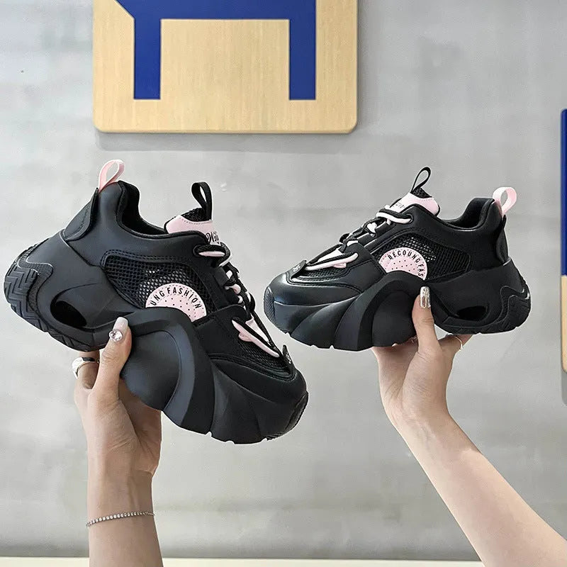 Women's pink sneakers with cross straps, thick sole, and mesh lining on a white background