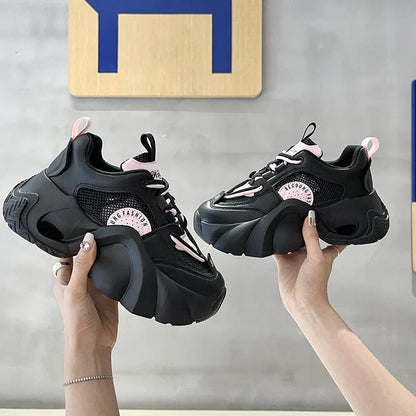 Women's pink sneakers with cross straps, thick sole, and mesh lining on a white background