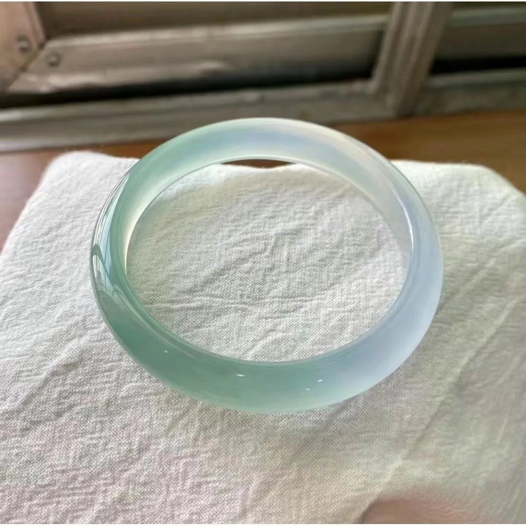 Natural agate wide tyre bracelet showing the stone's colour and the band's solid design on a wrist.