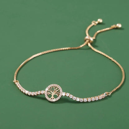 Close-up of a women's lucky tree design metal bracelet with zircon details on a wrist.