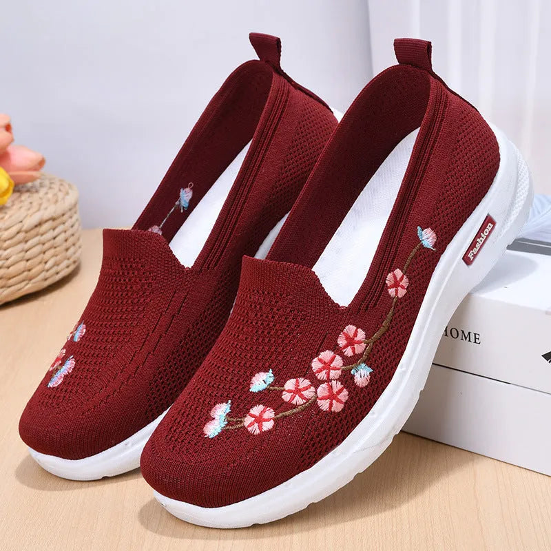 Women's low-top embroidered fly knit sports pumps in wine red with anti-slip sole.