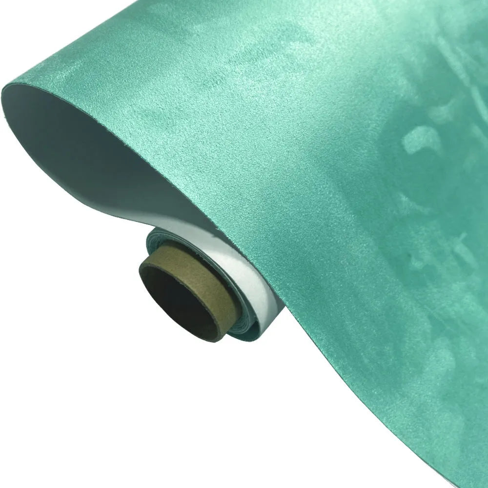 Rolls of self-adhesive leather suede in multiple colours showing texture and adhesive backing.