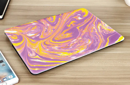 Plastic MacBook protective case in a marble pattern colour, shown next to a compatible Apple laptop.