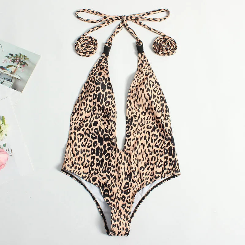 Backless leopard print one-piece swimsuit for women with a front buckle and bandage style design.
