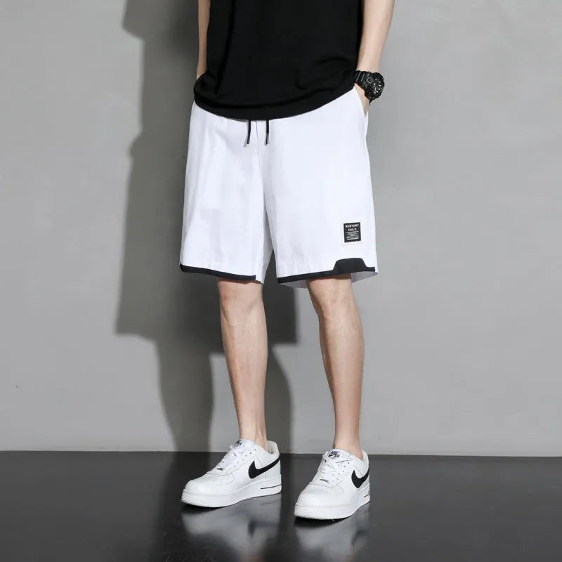 Cotton shorts for teenage boys in black, shown on a hanger, featuring a mid-waist design.