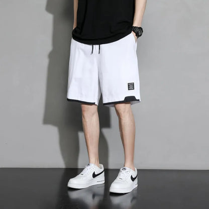 Cotton shorts for teenage boys in black, shown on a hanger, featuring a mid-waist design.