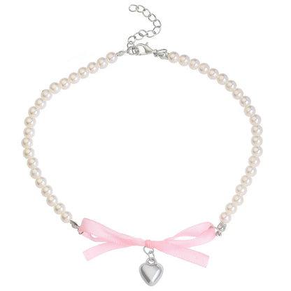 Love heart and bow tie clavicle chain necklace with pearl inlay, shown in White K Love 028 and White K Bow 026 options.