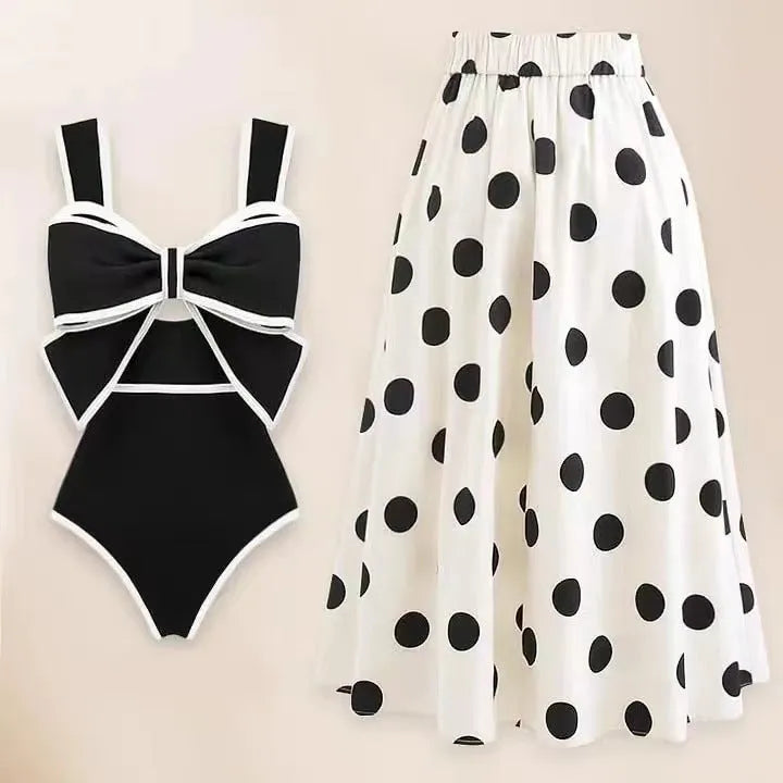 Women's black one-piece swimsuit with white skirt and bow detail for beach swimming