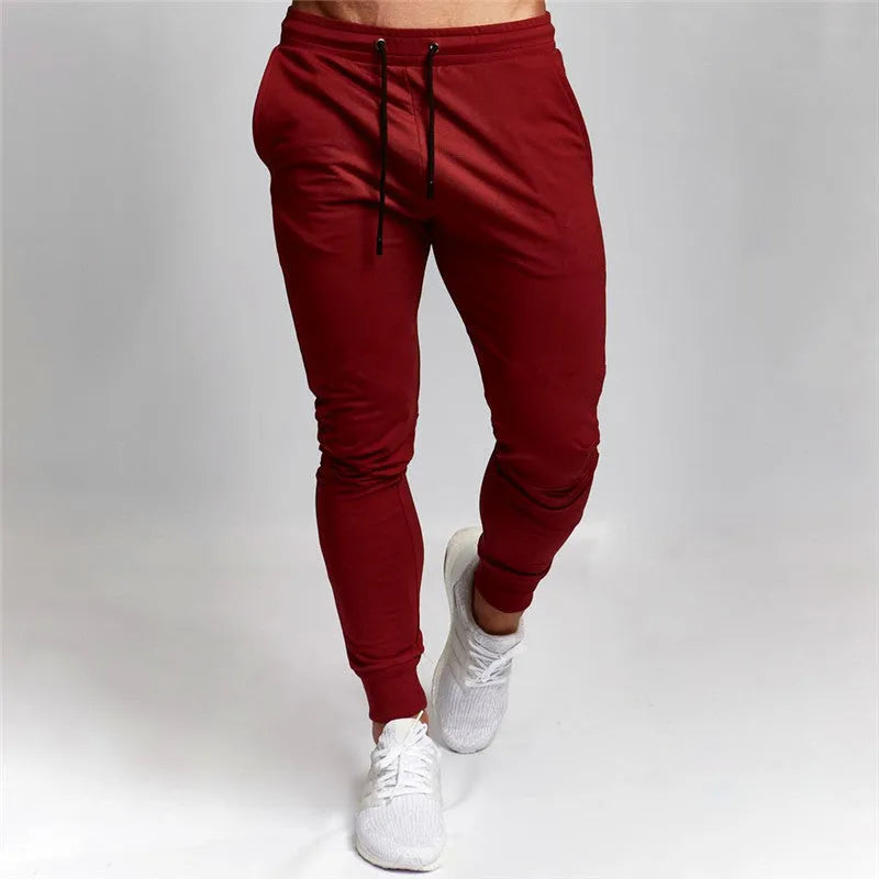 Men's cotton skinny sports trousers with drawstring and belt, available in five solid colours