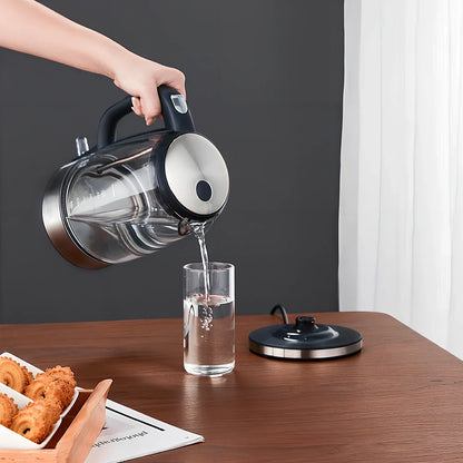 Transparent glass electric kettle showing water level scale and ergonomic handle