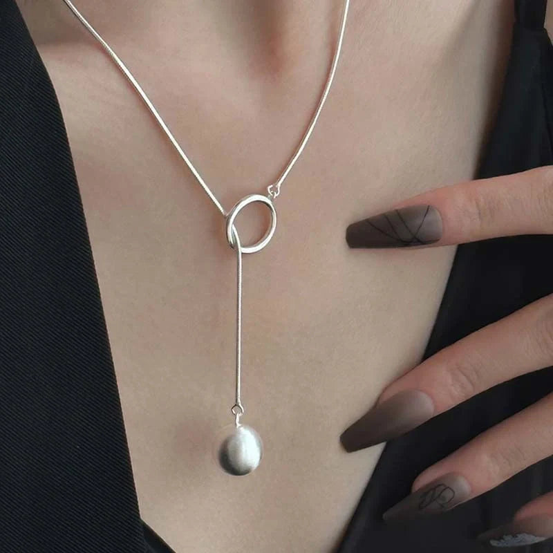 Elegant platinum plated ball necklace with a sleek snake bone chain, perfect for fashionable fall and winter accessorizing