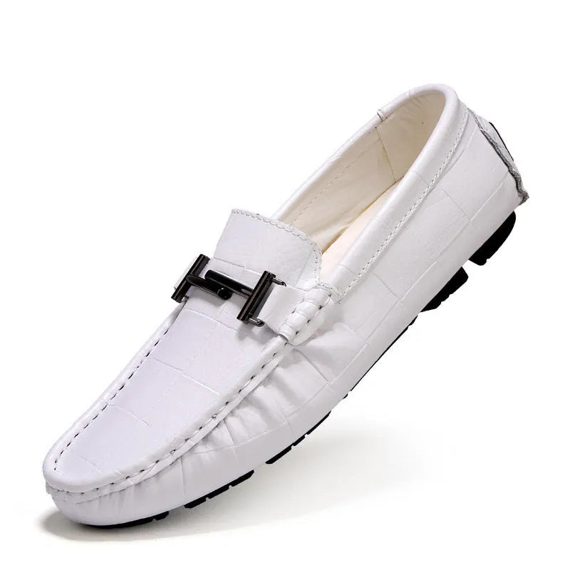Men's brown leather casual shoes with silver buckle fastening, showing textured rubber sole and low-cut design