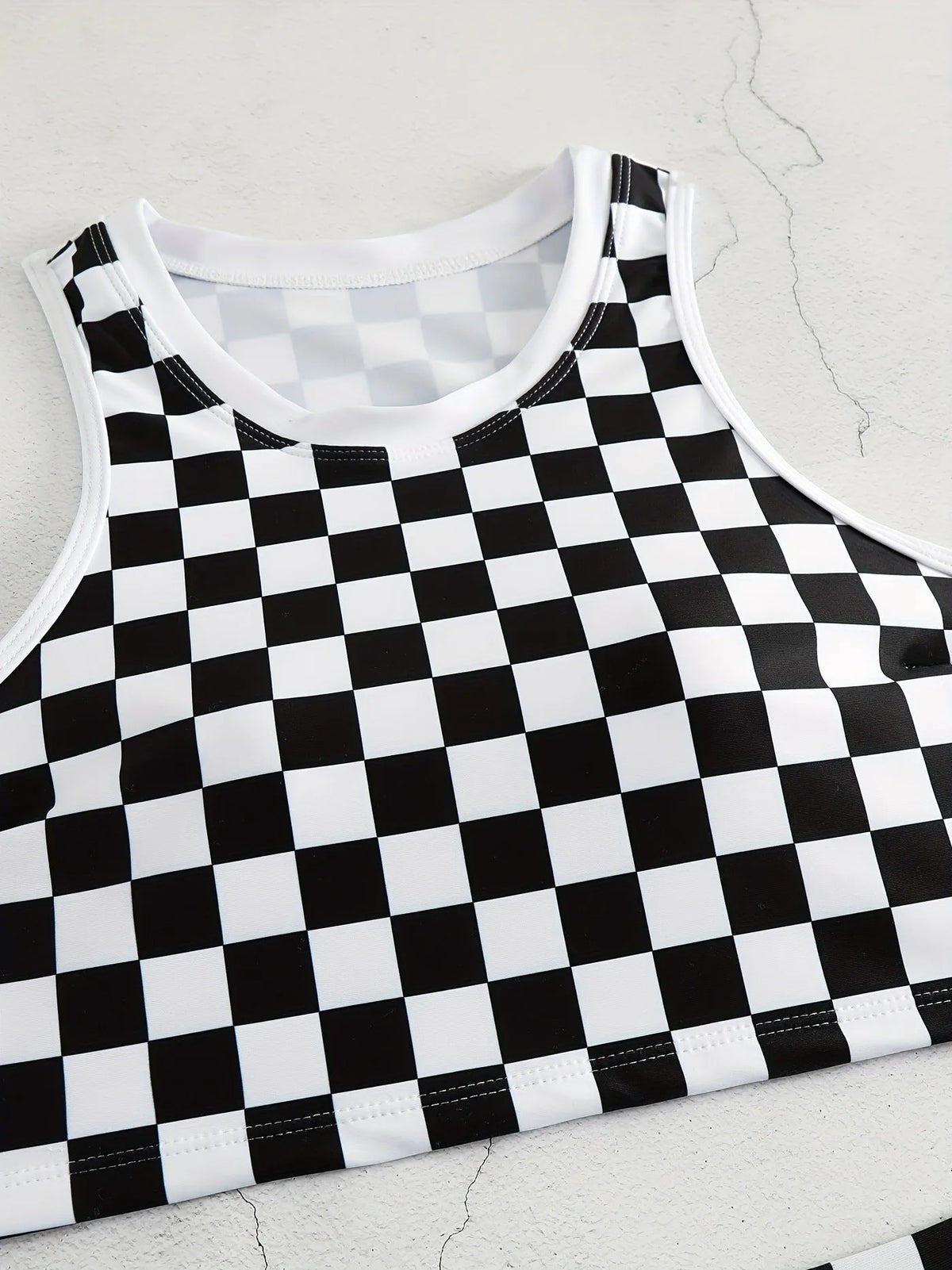 Women's black and white checkerboard print backless racing swimsuit with suspender straps