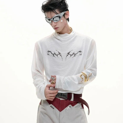 Man wearing a black slim-fit niche mesh long sleeve base layer shirt.