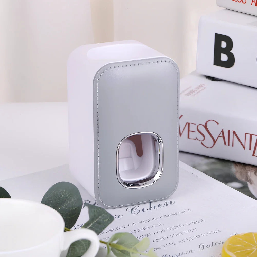 White automatic toothpaste dispenser mounted on bathroom wall with precise 0.8g portion dispensing