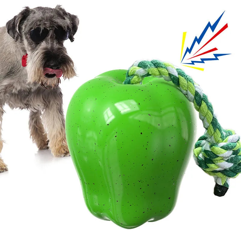 Green plastic dog toy shaped like a molar with ridges, sitting on grass as a slow feeder and chew toy.