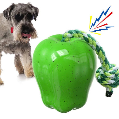 Green and red apple-shaped plastic dog toy with textured surface and a treat hole for interactive chewing.