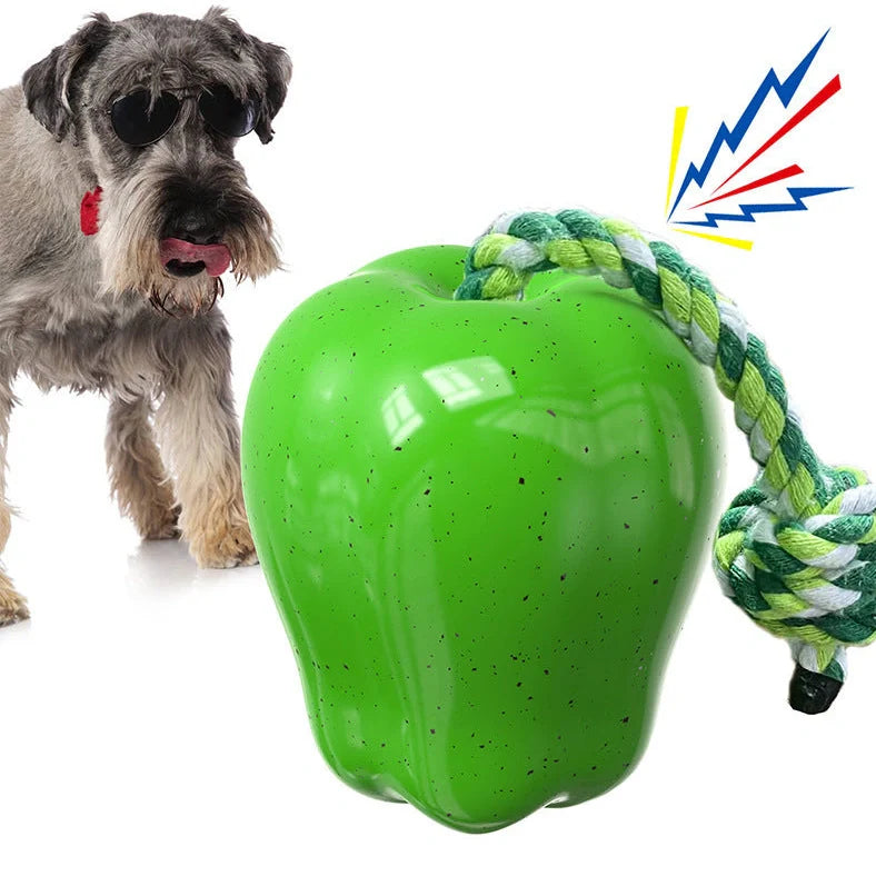 Green squeaky apple-shaped dog toy with treat-dispensing function, approximately 10-12cm diameter
