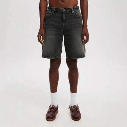Men's light blue loose-fit straight-leg cotton jeans on a neutral background.