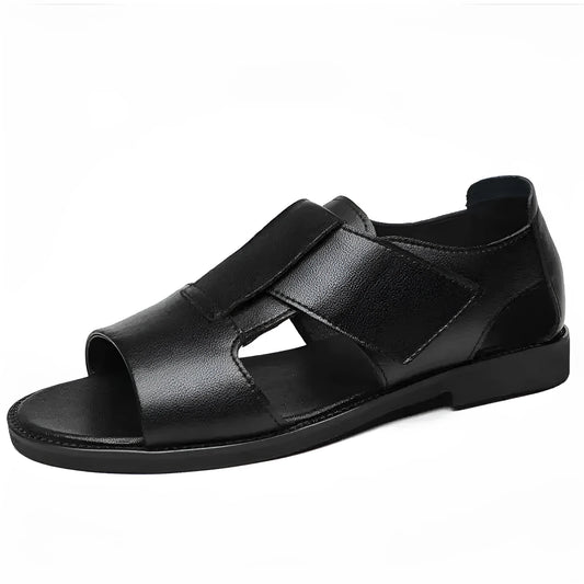 Men's brown leather Roman-style sandals with an open toe and a textured rubber sole on a wooden surface.
