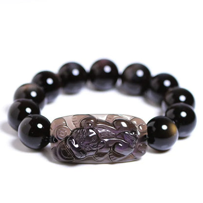Natural Icy Obsidian crystal Pi Xiu bracelet with polished beads in ethnic geometric style.