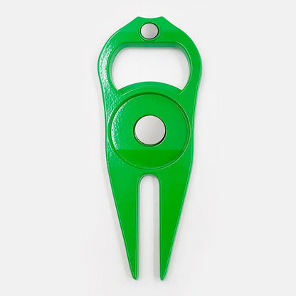 A black zinc alloy golf ball yoke tool with a bottle opener and a separate ball coin on a putting green.
