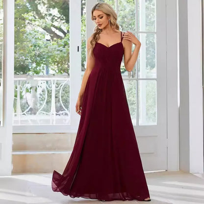 Women's sleeveless long dress with sling neckline and pleated A-line skirt in a solid colour.
