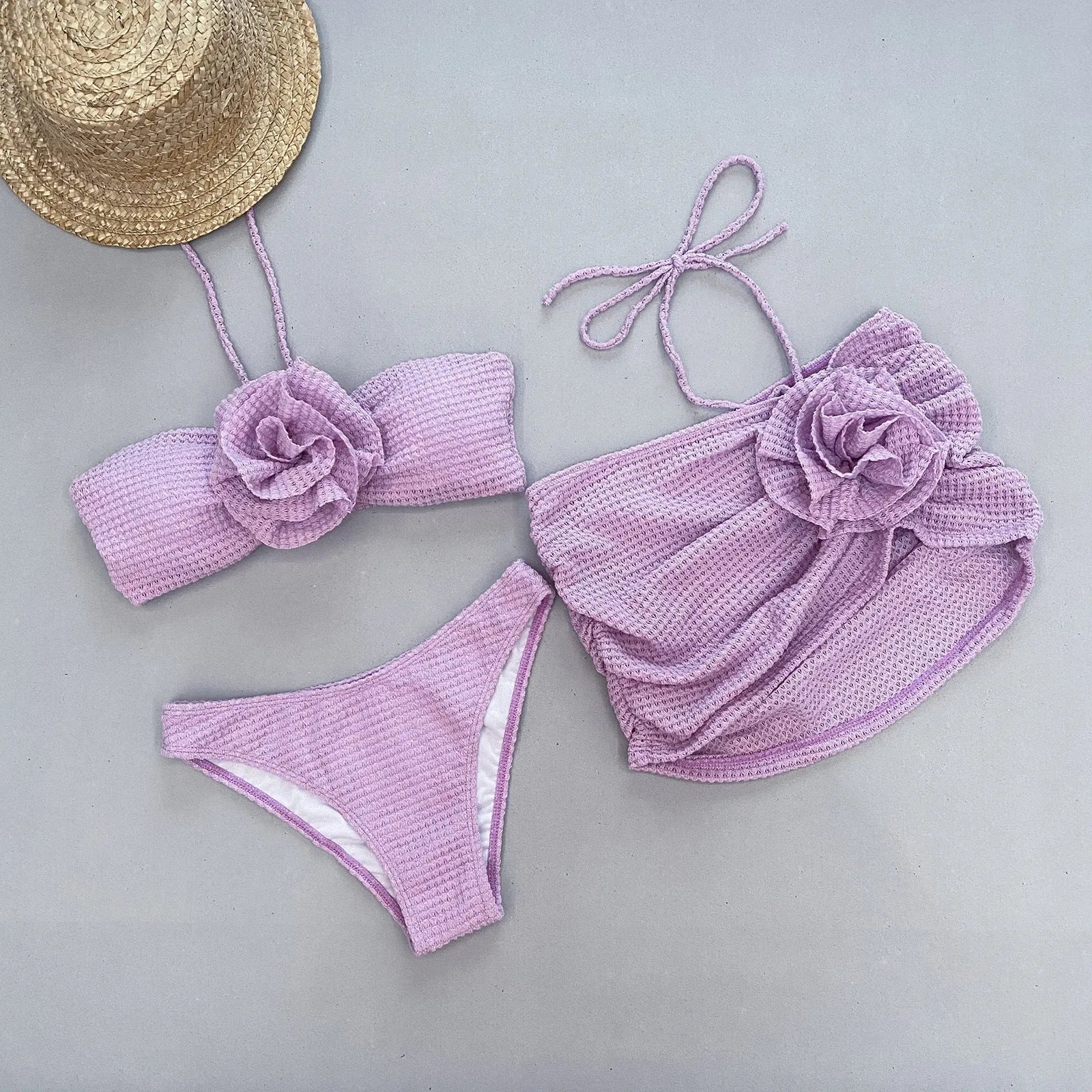 White three-piece women's bikini with 3D flower split design on a mannequin.