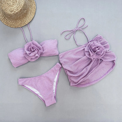 White three-piece women's bikini with 3D flower split design on a mannequin.