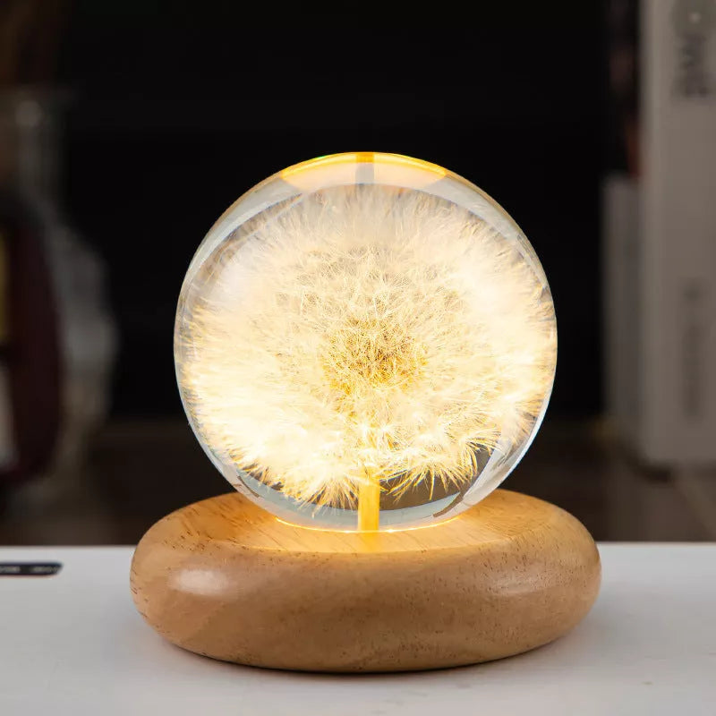 LED Dandelion Crystal Ball Night Light with oak base emitting soft glow