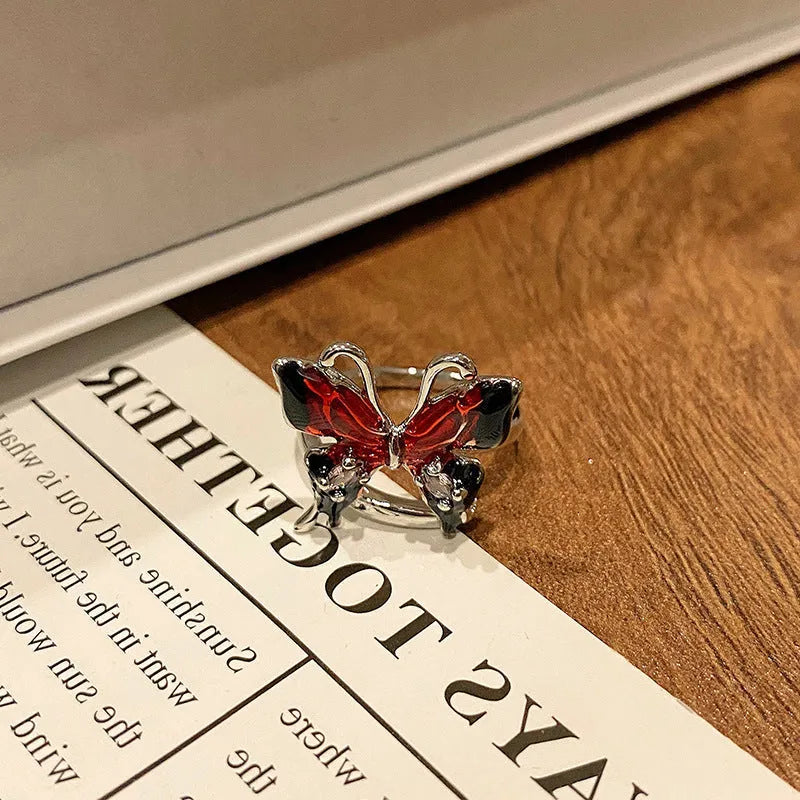 Copper women's ring with Chinese butterfly design and adjustable open loop.