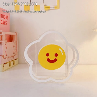Square transparent acrylic storage box with printed character theme containing coloured pens