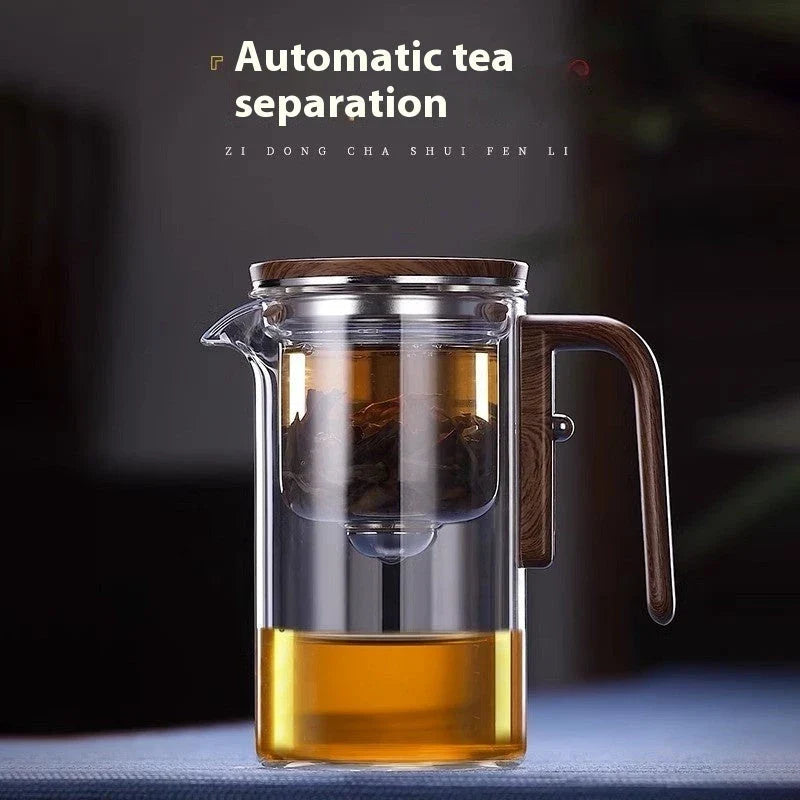 Elegant glass tea infuser pot with magnetic separation technology, wooden handle, and precise pouring spout