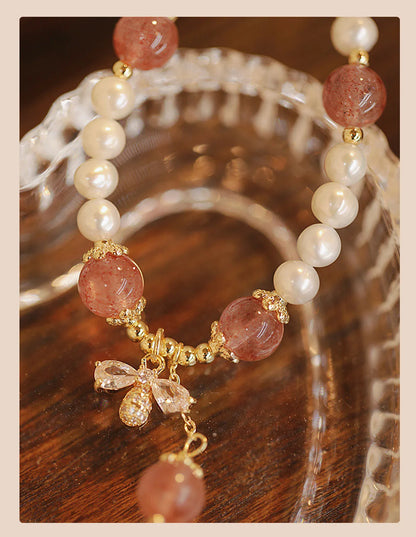 Women's adjustable Strawberry Quartz crystal bracelet with bow charm on wrist