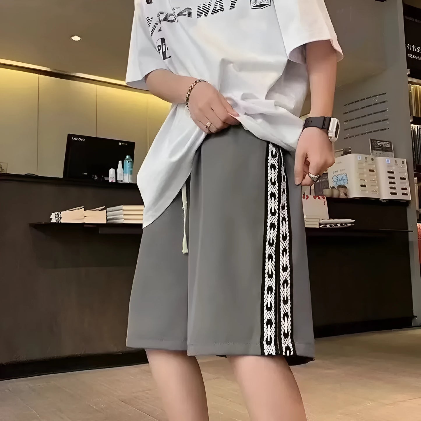 Man wearing loose-fit black baggy track pants with an elasticated waist for casual athletic wear