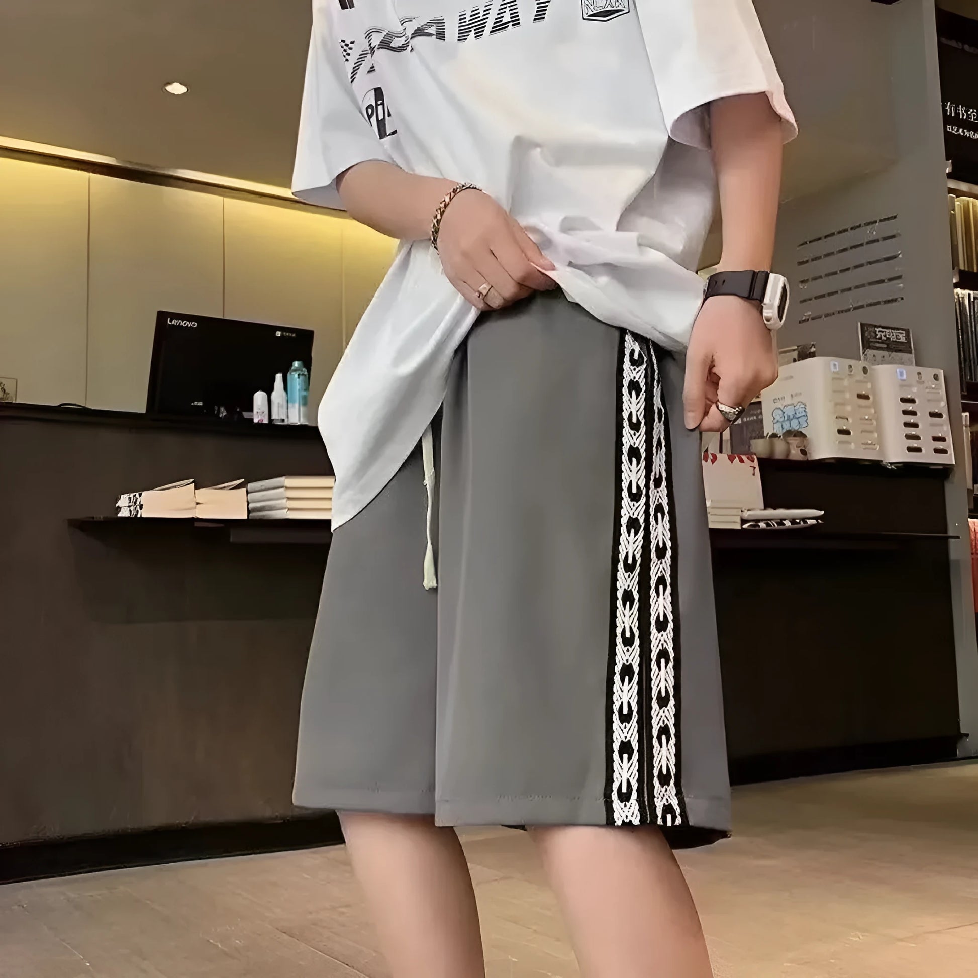 Man wearing loose-fit black baggy track pants with an elasticated waist for casual athletic wear