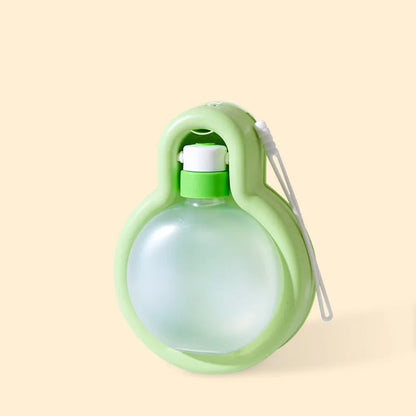 Green pet travel cup with integrated bowl for dogs, showing leak-proof design and portable size